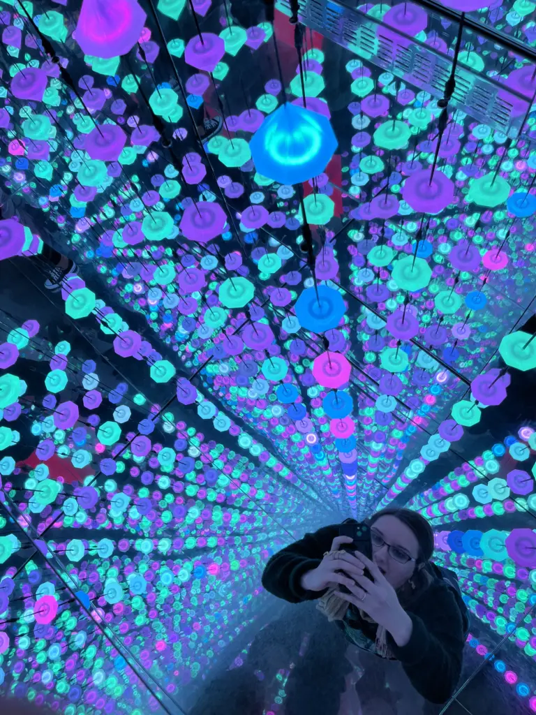 Magdalena Zarowiecki inside a mirrored hall of glowing LED orbs
